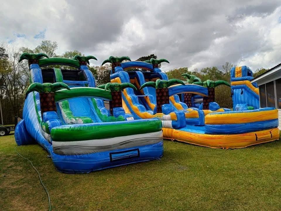 Child playing on a real Summers & Sons bounce house and slide combo unit set up in a backyard